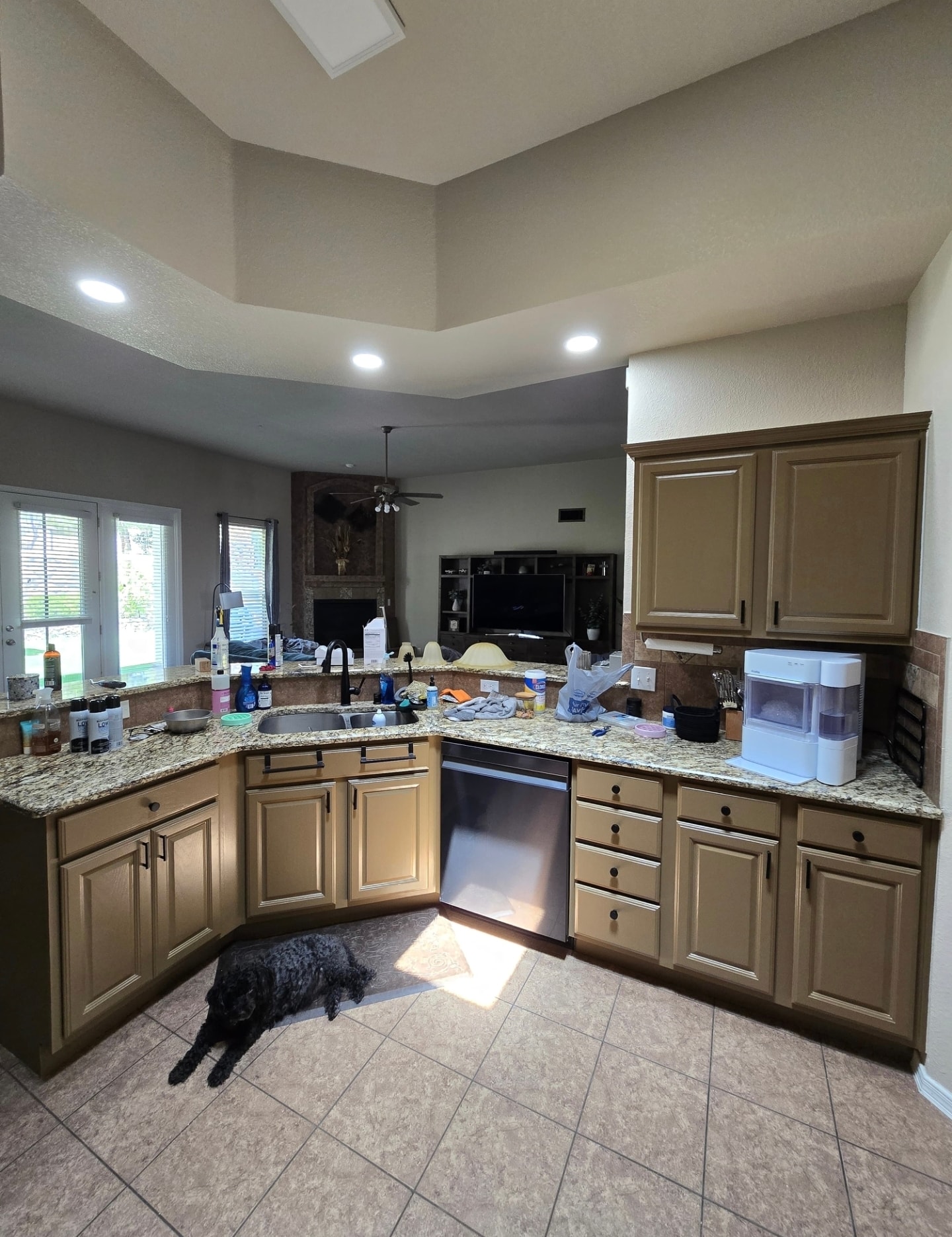 Refinished tan kitchen cabinets with granite countertops and open floor plan