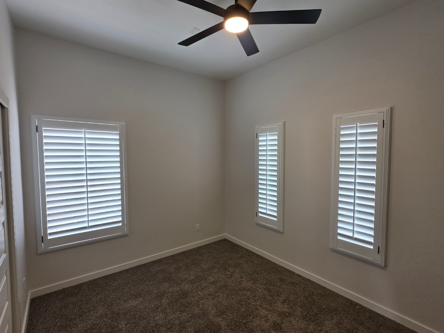 Plantation shutters on three bedroom windows with ceiling fan