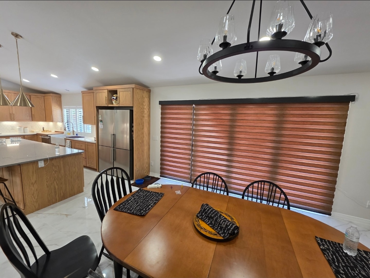 Walnut-tone zebra shades on a large dining room window