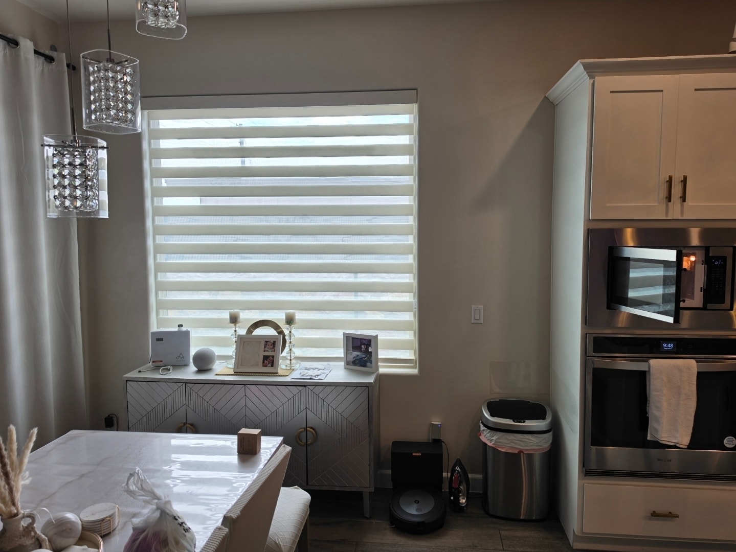 White zebra shades in a kitchen and dining area